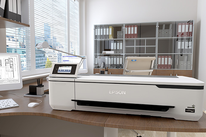 Epson SureColor T3170 instalada en una oficina técnica junto a planos y computador